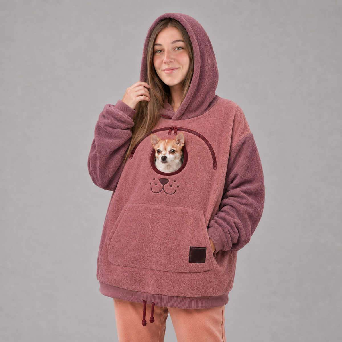 Pink Pet Carrier Hoodie with a small dog in the front pouch